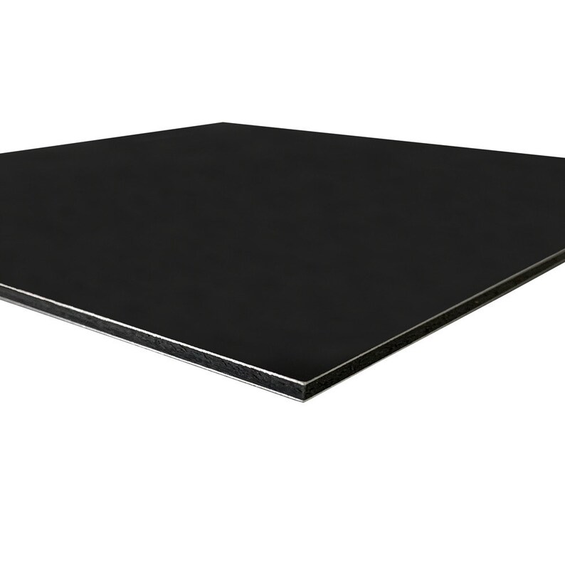 May include: A black rectangular panel with a silver edge. The panel has a smooth, matte finish and is angled slightly towards the viewer, showcasing its clean lines and modern aesthetic.