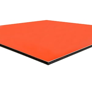 May include: A square, orange panel with a glossy finish. The panel has a black edge and a silver core. The product is viewed at a slight angle against a white background.