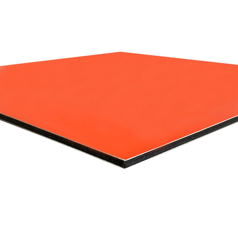 May include: A square, orange panel with a glossy finish. The panel has a black edge and a silver core. The product is viewed at a slight angle against a white background.