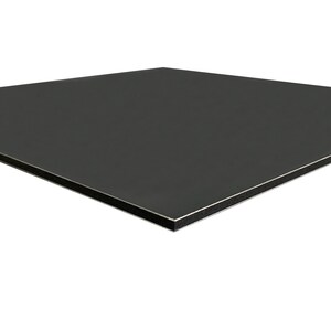 May include: A square, dark gray panel with a smooth, matte finish. The edges are framed with a thin silver border and a black core. The panel appears to be made of a composite material.