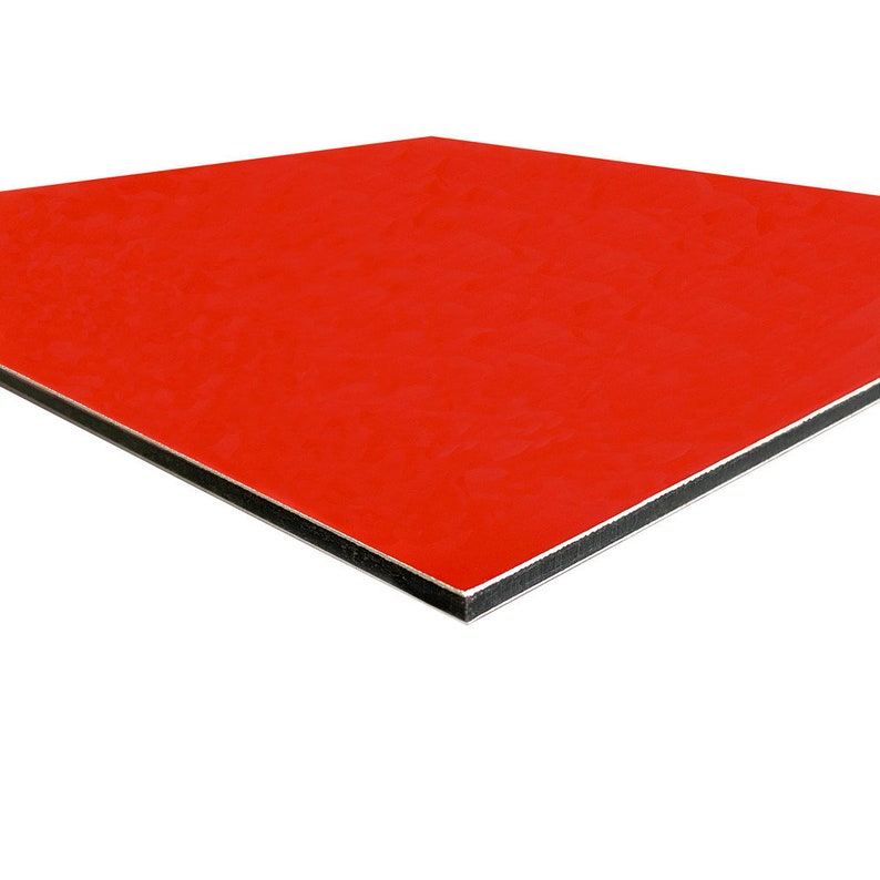 May include: A square, red panel with a glossy finish. The panel has a black core and a silver edge. The product is likely a building material or decorative element.