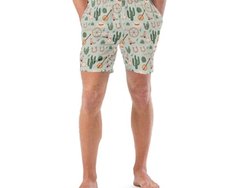 May include: Light blue swim trunks with a repeating pattern of cowboy-themed illustrations. The design includes horseshoes, cacti, guitars, and wagon wheels. The shorts have a comfortable, casual style.
