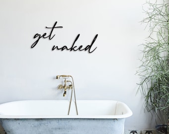 May include: A white bathtub with gold faucets and a black sign on the wall that says "get naked".