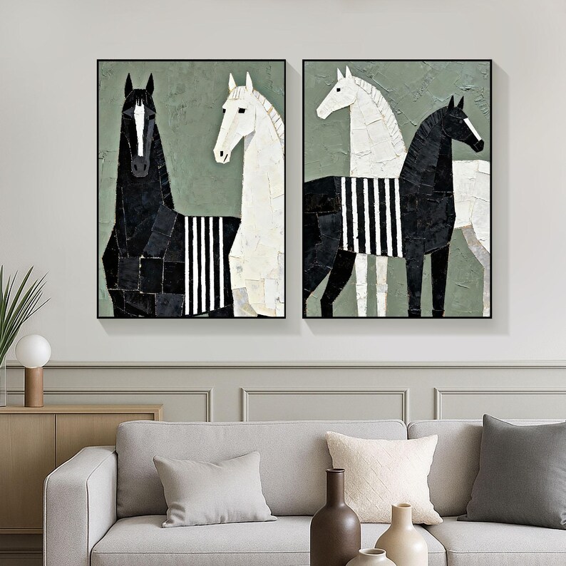 May include: Two framed abstract horse paintings. One features a black horse with white stripes, the other a white horse with black stripes. Both have a green background and are displayed above a gray sofa.