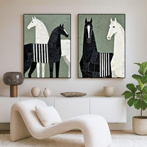 May include: Two framed abstract horse paintings. One painting features a black horse with white stripes and a white horse. The other painting features a black horse and a white horse. The background is a muted green.