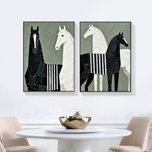May include: Two framed abstract art pieces featuring horses. One painting shows a black horse and a white horse, both with striped details. The other painting shows a white horse and a black horse, also with striped details. The background is a muted green.