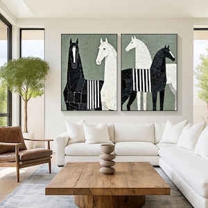 May include: Two framed abstract paintings of horses. One painting features a black horse with a white stripe pattern, and the other features a white horse with a black stripe pattern. The background is a muted green.