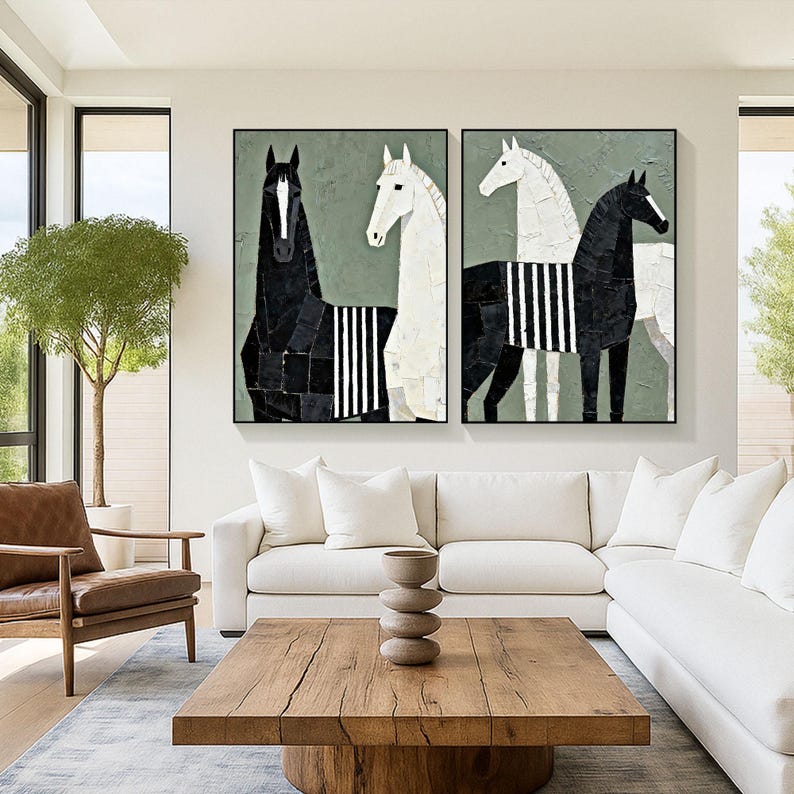 May include: Two framed abstract paintings of horses. One painting features a black horse with a white stripe pattern, and the other features a white horse with a black stripe pattern. The background is a muted green.