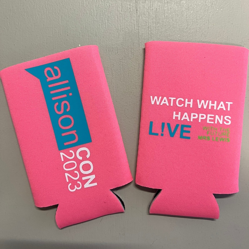 May include: Two pink can coolers with text. One cooler has "allison CON 2023" in white and teal. The other cooler has "WATCH WHAT HAPPENS LIVE" in white and teal, with a quote in green.