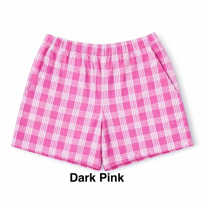 K&ouml;nnte beinhalten: Eine Shorts mit einem lebendigen dunkelrosa-wei&szlig;en Karomuster. Die Shorts verf&uuml;gt &uuml;ber einen elastischen Bund und zwei Seitentaschen. Der Stoff zeigt ein durchgehendes, gleichm&auml;&szlig;iges Gitterdesign, das dem Kleidungsst&uuml;ck eine strukturierte Optik verleiht.