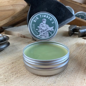 May include: A green tin of wood polish with the label "Big Timber's Protect & Polish" and a cartoon image of a man holding a variety of woodworking tools.