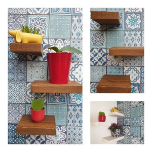 May include: Three wooden shelves mounted on a blue and white tiled wall. The shelves are decorated with potted plants, including a succulent, a small green plant, and a yellow rubber duck.