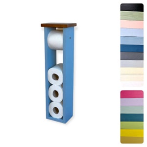 May include: A blue wooden toilet paper holder with a brown top and three rolls of toilet paper.