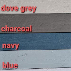 May include: A color palette featuring painted wooden planks in various shades. Colors include white, off-white, ecru, dove grey, charcoal, navy, blue, baby blue, baby pink, and sage. Each color is labeled with a corresponding text.
