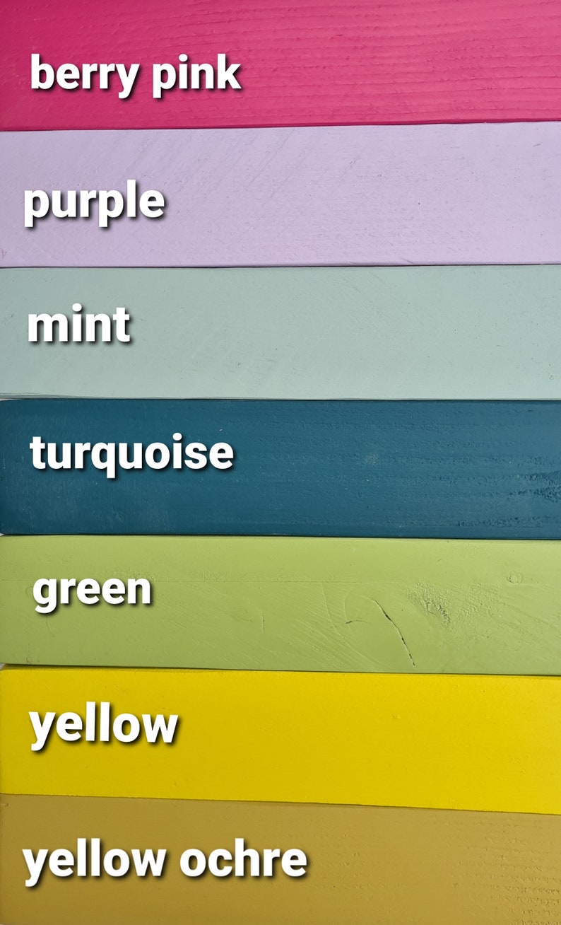 May include: A vertical image showcasing seven painted wooden planks in various colors. The colors include berry pink, purple, mint, turquoise, green, yellow, and yellow ochre. Each plank has the color name in white text.
