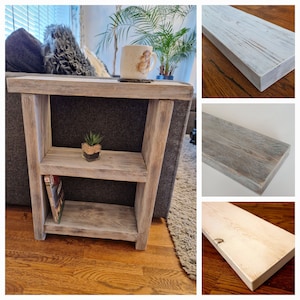 May include: A whitewashed wooden end table with two shelves. The table has a rustic, farmhouse style and is perfect for a living room or bedroom.