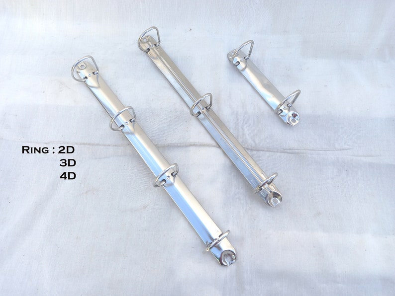 May include: Three silver binder rings, with 2, 3, and 4 rings, respectively.  RING: 2D 3D 4D