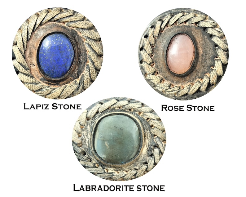 May include: Three round leather and stone embellishments with a braided border. The stones are lapis lazuli, rose quartz, and labradorite.
