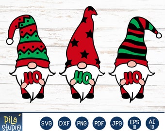 May include: Three Christmas gnome illustrations with red and green hats, white beards, and the word "HO" in the center. The gnomes have different hat patterns, including stars and stripes. The image is set against a light wood background.