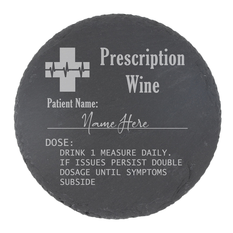 May include: A round black slate coaster with a white medical cross and the text "Prescription Wine". The text "Patient Name: Name Here" and "DOSE: DRINK 1 MEASURE DAILY. IF ISSUES PERSIST DOUBLE DOSAGE UNTIL SYMPTOMS SUBSIDE" is also engraved on the coaster.