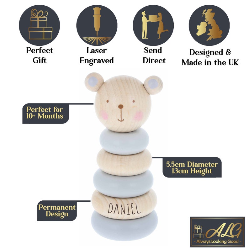 May include: A wooden stacking toy shaped like a bear with a light blue and natural wood colour scheme. The toy has five rings and the bottom ring is personalised with the name "DANIEL". The toy is 5.5cm in diameter and 13cm tall.