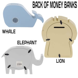 May include: Back view of three wooden money banks shaped like a whale, elephant, and lion. The whale is light blue, the elephant is grey, and the lion is beige. Each bank has a slot for coins on the top.