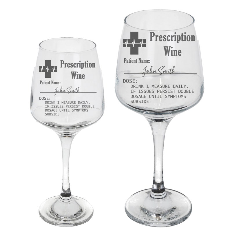 May include: Two clear glass wine glasses with a prescription label design. The label says "Prescription Wine" and includes a medical symbol, patient name, and dosage instructions. The text on the label reads: "Prescription Wine", "Patient Name: John Smith", "DOSE: DRINK 1 MEASURE DAILY. IF ISSUES PERSIST DOUBLE DOSAGE UNTIL SYMPTOMS SUBSIDE."