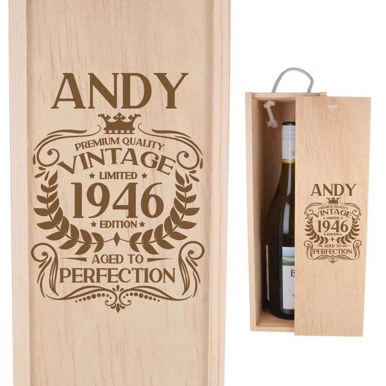 May include: A light-colored wooden wine box featuring a sliding lid engraved with the name ANDY, a crown icon, and the text PREMIUM QUALITY VINTAGE 1946 LIMITED EDITION AGED TO PERFECTION. A wine bottle is visible inside the open wooden container.