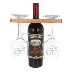 May include: A wooden wine rack with a bottle of red wine and four wine glasses. The wine bottle is labeled "Bartolomeo Lorenzi Amarone della Valpolicella" and the glasses have engraved initials.