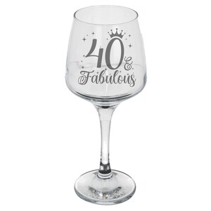 May include: Clear glass wine glass with a silver design that says "40 & Fabulous" with a crown above the 40.