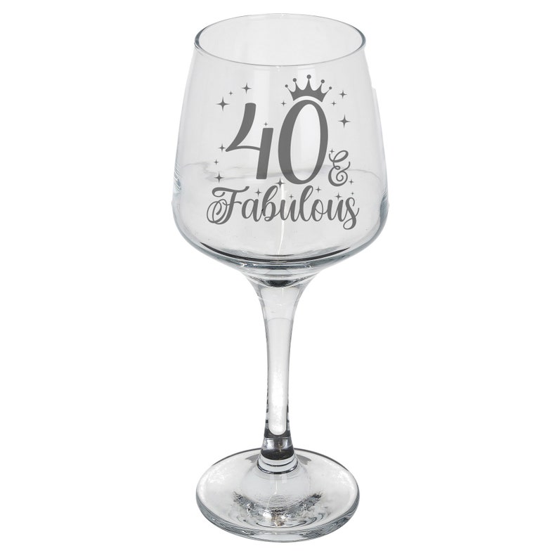 May include: Clear glass wine glass with a silver design that says "40 & Fabulous" with a crown above the 40.
