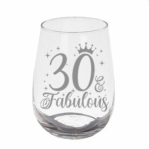 May include: Clear glass wine glass with a silver design that says "30 & Fabulous" with a crown above the 30.