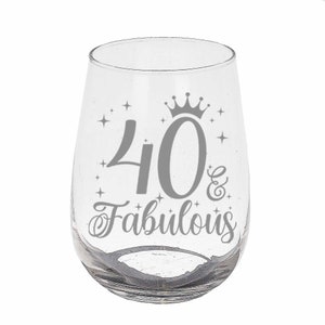 May include: A clear glass wine glass with a silver design that says "40 & Fabulous" with a crown above the number 40.
