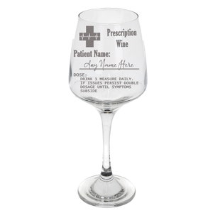 May include: A clear glass wine glass with a gray inscription that reads "Prescription Wine" and "Patient Name: Any Name Here". The inscription also includes a medical symbol with a heart rate line and the text "DOSE: DRINK 1 MEASURE DAILY. IF ISSUES PERSIST DOUBLE DOSAGE UNTIL SYMPTOMS SUBSIDE."