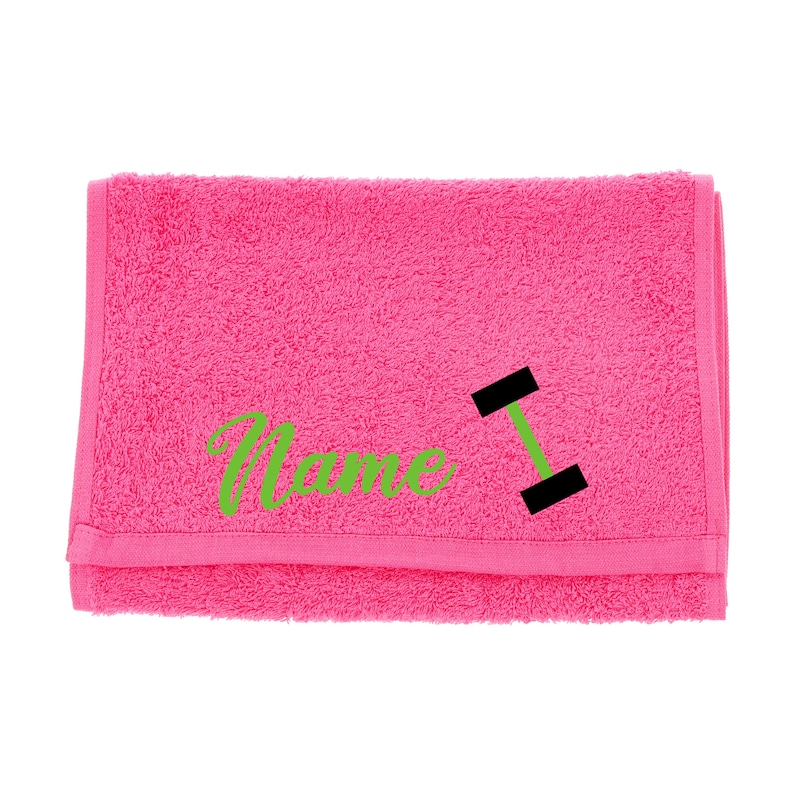Puede incluir: Toalla rosa con la palabra "Name" y un gr&aacute;fico de mancuerna negra bordado en verde.