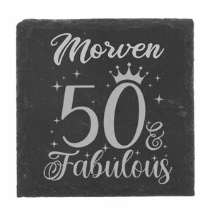 May include: Black slate coaster with the text "Morven 50 & Fabulous" in silver lettering. A crown is above the number 50.