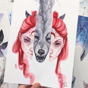May include: Watercolor painting of a woman with red hair and a wolf's face. The woman's face is split in half, with the wolf's face taking up the other half. The wolf's face is snarling, and the woman's face is looking down. The painting is done in a realistic style, with a lot of detail in the fur and the skin.
