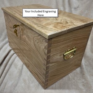 May include: A wooden chest with a brass handle and a keyhole. The top of the chest has the text "Your Included Engraving Here".