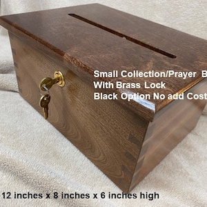 May include: A small wooden box with a slot on top and a brass lock. The box is 12 inches long, 8 inches wide, and 6 inches high. It is labeled "Small Collection/Prayer Box with Brass Lock Black Option No add Cost".