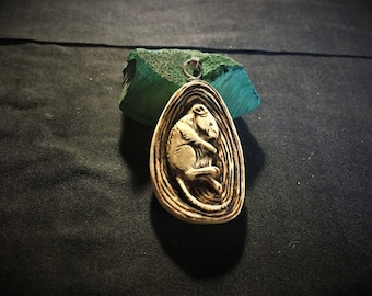 Mouse amulet carved in bone and silver.