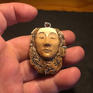 Amulet of the goddess of the earth Gaia. Made of buffalo bone, ebony wood and silver