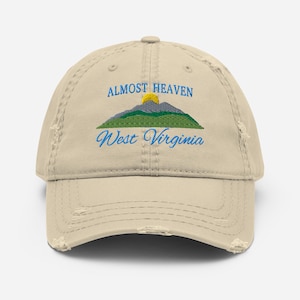 May include: A beige distressed baseball cap with an embroidered design of a mountain range with a sun and the text "Almost Heaven West Virginia".