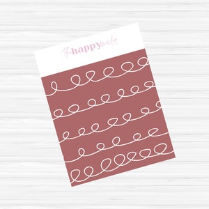 May include: A stationery item with a white top and a dusty rose bottom. The bottom section features a repeating pattern of white, looping lines. The text "thehappymailer" is written in a light pink script font on the white top.