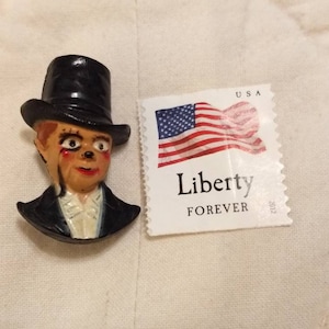 Vintage Bakelite lapel pin of Charlie McCarthy, the ventriloquist Edgar Bergen's dummy who ruled TV from 1930 to 1979.