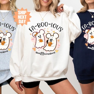 May include: Three sweatshirts in gray, white, and navy blue, each featuring a Halloween-themed graphic. The design includes two ghost characters, pumpkins, and the text "FA-BOO-LOUS" and "Walt Disney World".