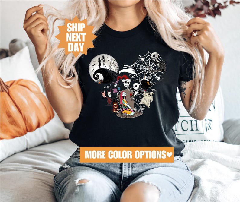 a woman sitting on a couch wearing a mickey mouse shirt