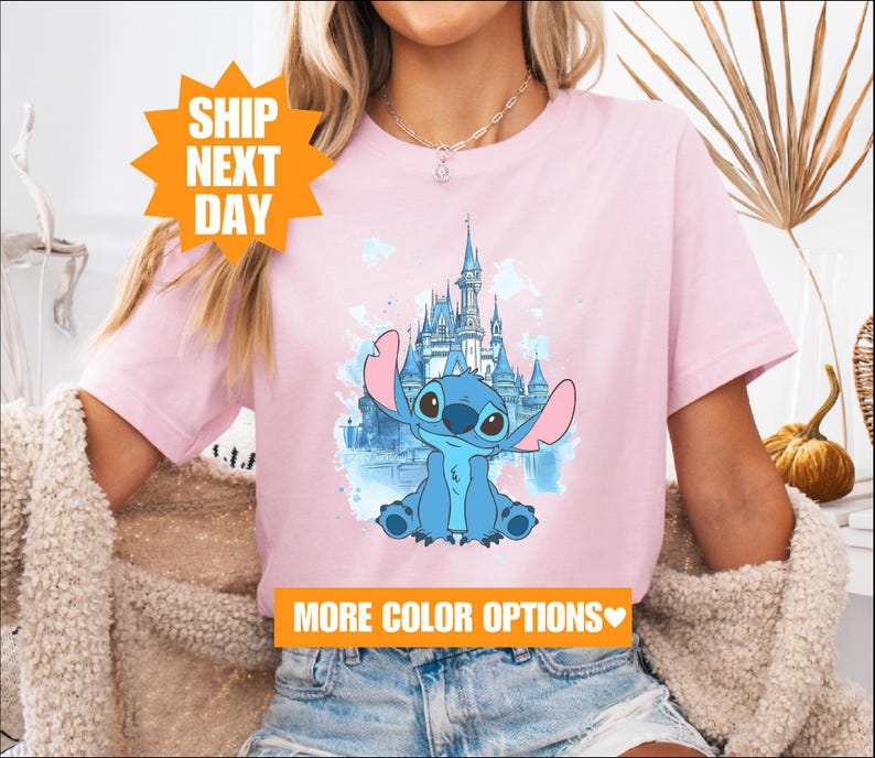 a woman wearing a pink shirt with an image of a cartoon character on it