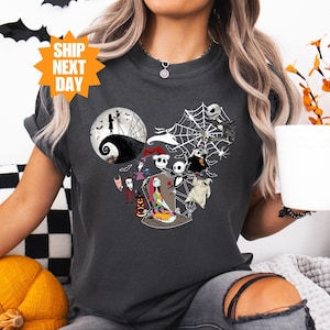 a woman holding a cup of coffee wearing a mickey mouse shirt