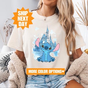 a woman wearing a t - shirt with a picture of a cartoon character on it