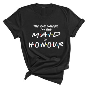 May include: Black t-shirt with white text that reads "The One Where I'm The Maid Of Honour" in a font reminiscent of the show Friends. The text has colorful dots around it.